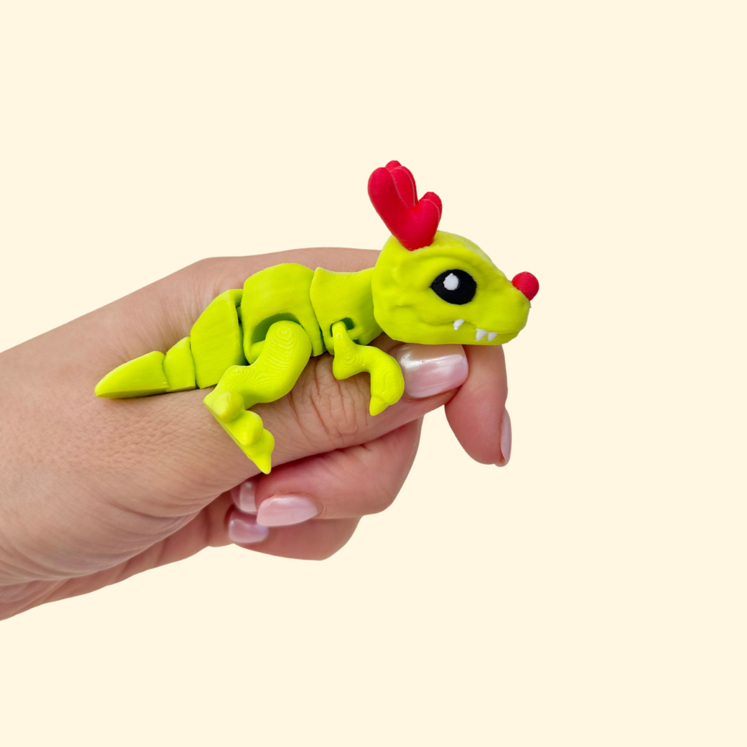 Articulated T-Rex fidget, 6.5 cm, textured scales, bright colours, tactile hand toy for sensory regulation.
