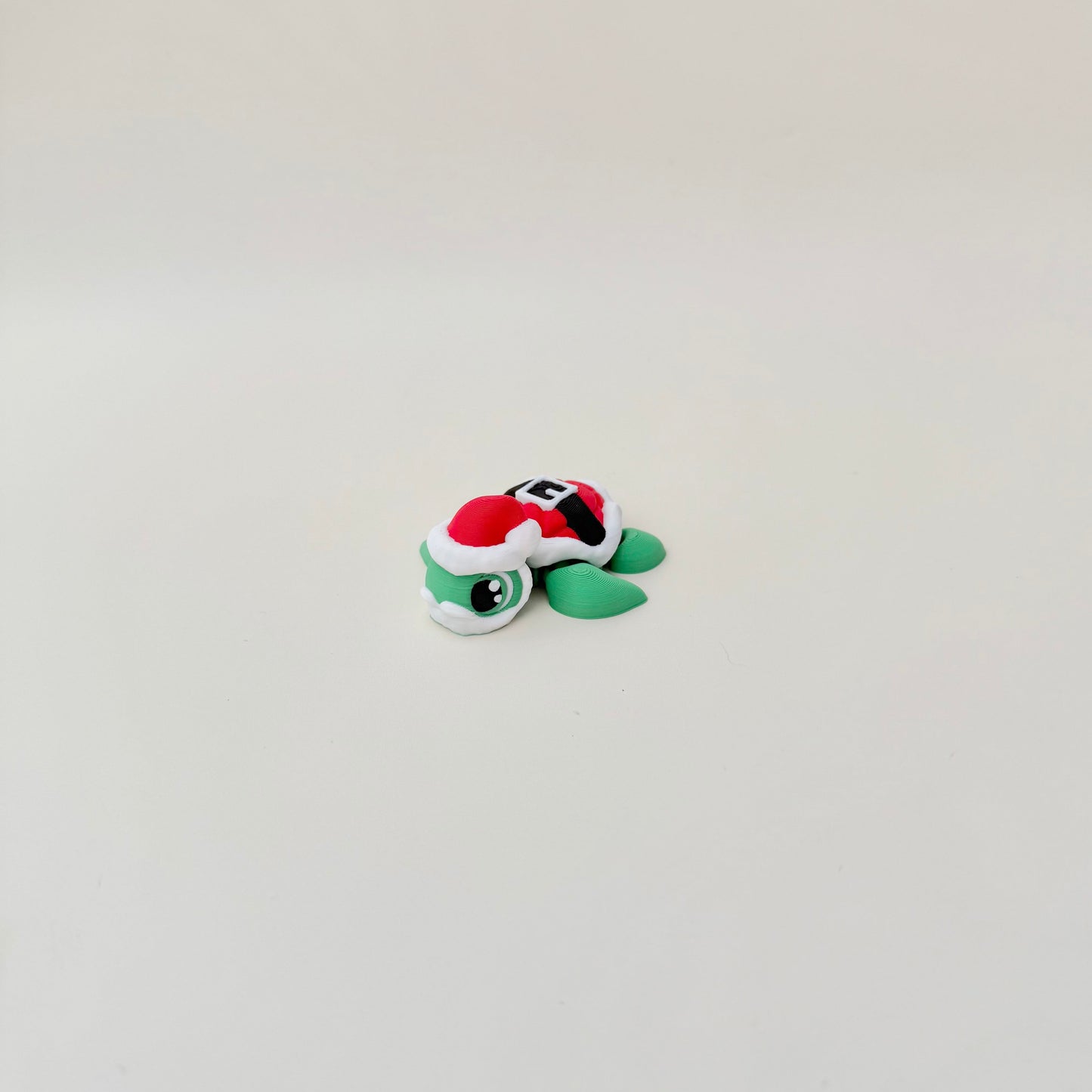 Mini turtle figure in holiday colours for desks, stockings or gift add-ons.
