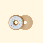 A magnetic doughnut fidget toy designed for sensory play, featuring a beige base, glossy white icing, and blue and green sprinkles.