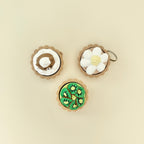 Small handheld tart fidgets with keyring loops and textured clicker centres.