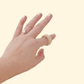 Close-up of the FidgiRing in a neutral nude tone, designed for discreet fidgeting, with a smooth spinning mechanism.