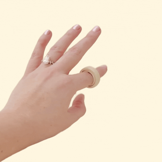 Close-up of the FidgiRing in a neutral nude tone, designed for discreet fidgeting, with a smooth spinning mechanism.