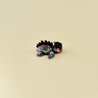 Small dragon-inspired turtle fidget with dramatic red eyes and movable limbs for focus and stress relief.