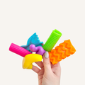Soft textured fidget shapes with a finger hole for discreet tracing and calming sensory regulation at desks or on the go.

