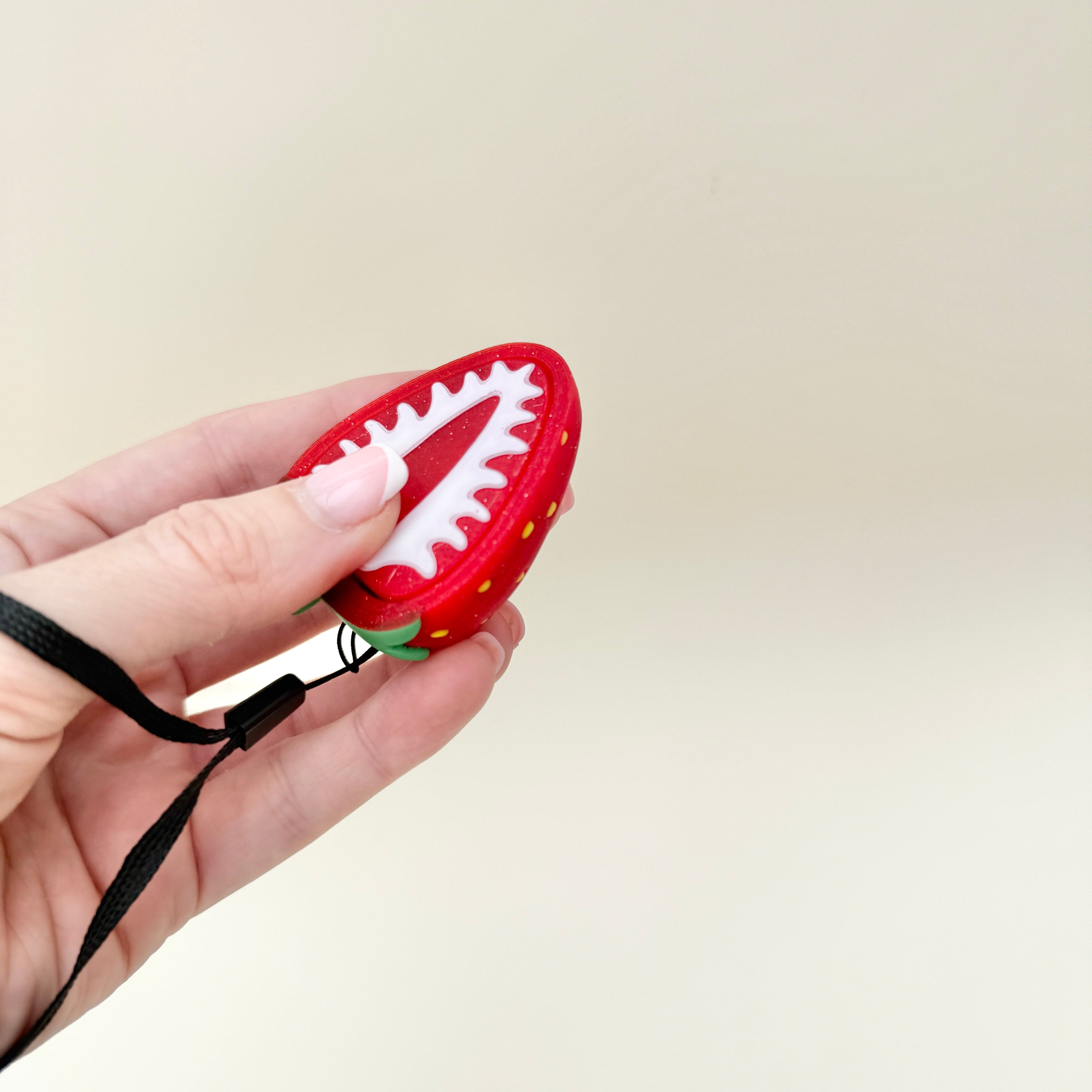 glitter red strawberry slice clicker toy designed for tactile stimming
