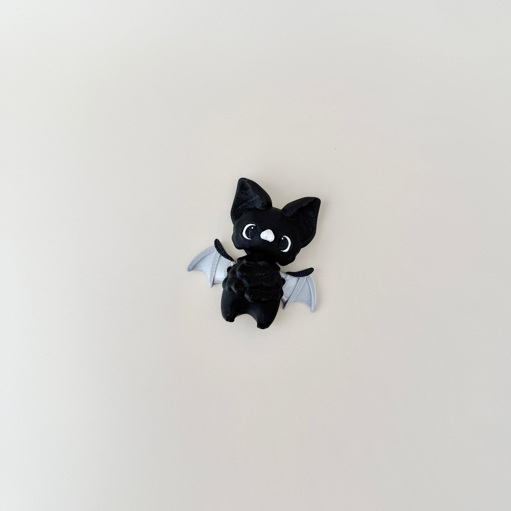 Fully articulated bat fidget toy featuring a compact design for portable fun.
