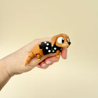 A dachshund-inspired fidget toy, designed for wiggling and movement, perfect for stress relief and sensory play.