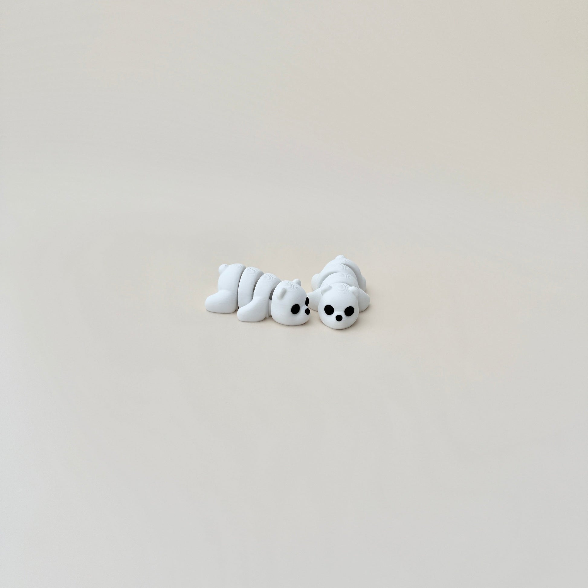 Articulated polar bear fidget toy in a sitting position, perfect for focus and stress relief.