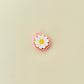 Lightweight clicker fidget toy shaped like a daisy for portable sensory play.
