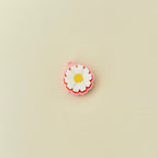 Lightweight clicker fidget toy shaped like a daisy for portable sensory play.