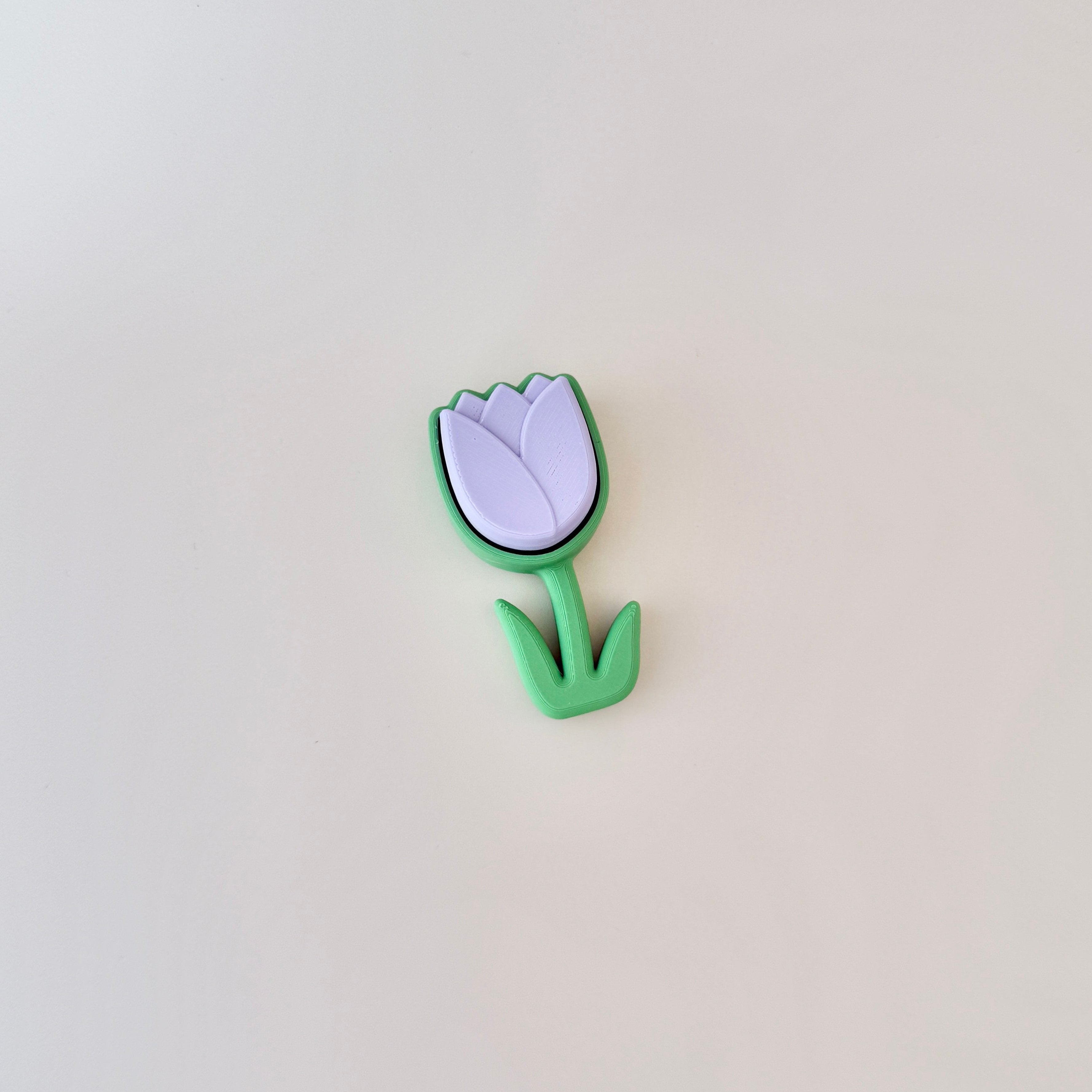 Tulip flower fidget toy in lilac and green with a smooth click motion for focus and calming.