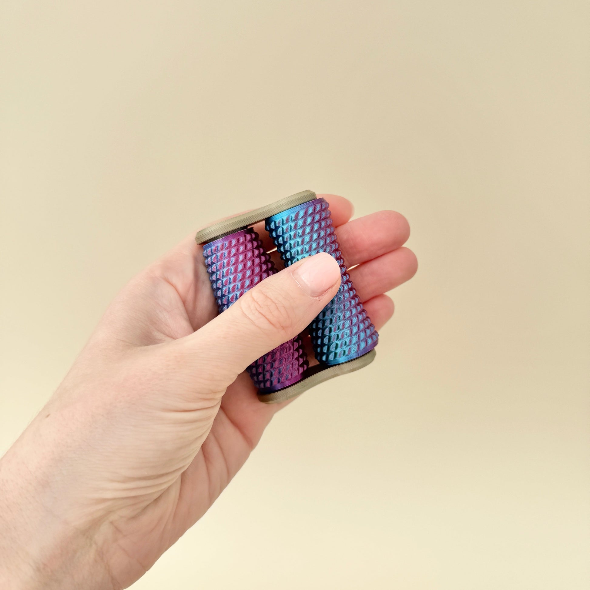A portable, deeply textured fidget toy that rolls effortlessly between the fingers.