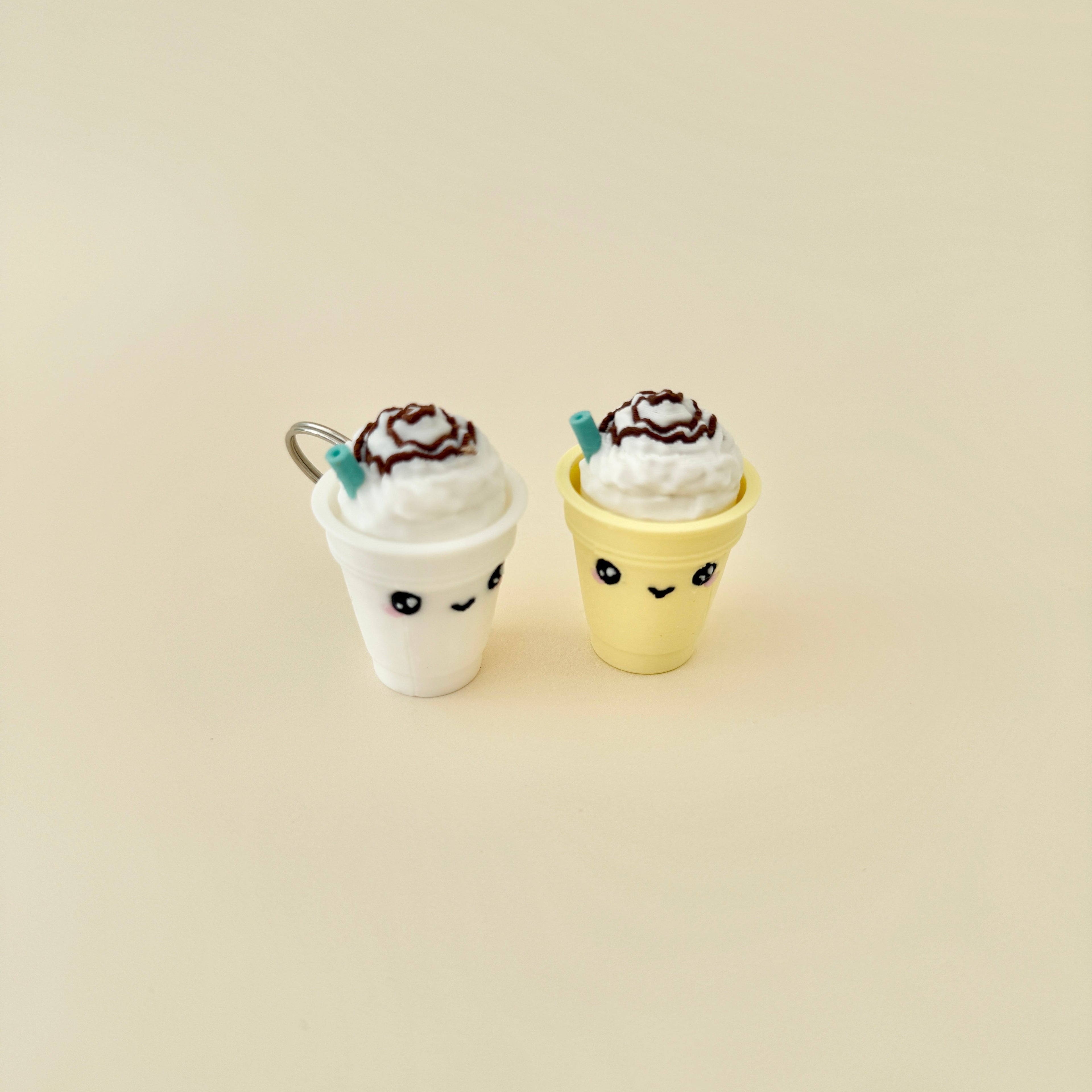 A coffee-themed fidget toy shaped like a frappe with a whipped cream top and straw, featuring a clicker.