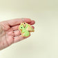 Small textured clicker fidget with a dragon design and soft raised detailing.