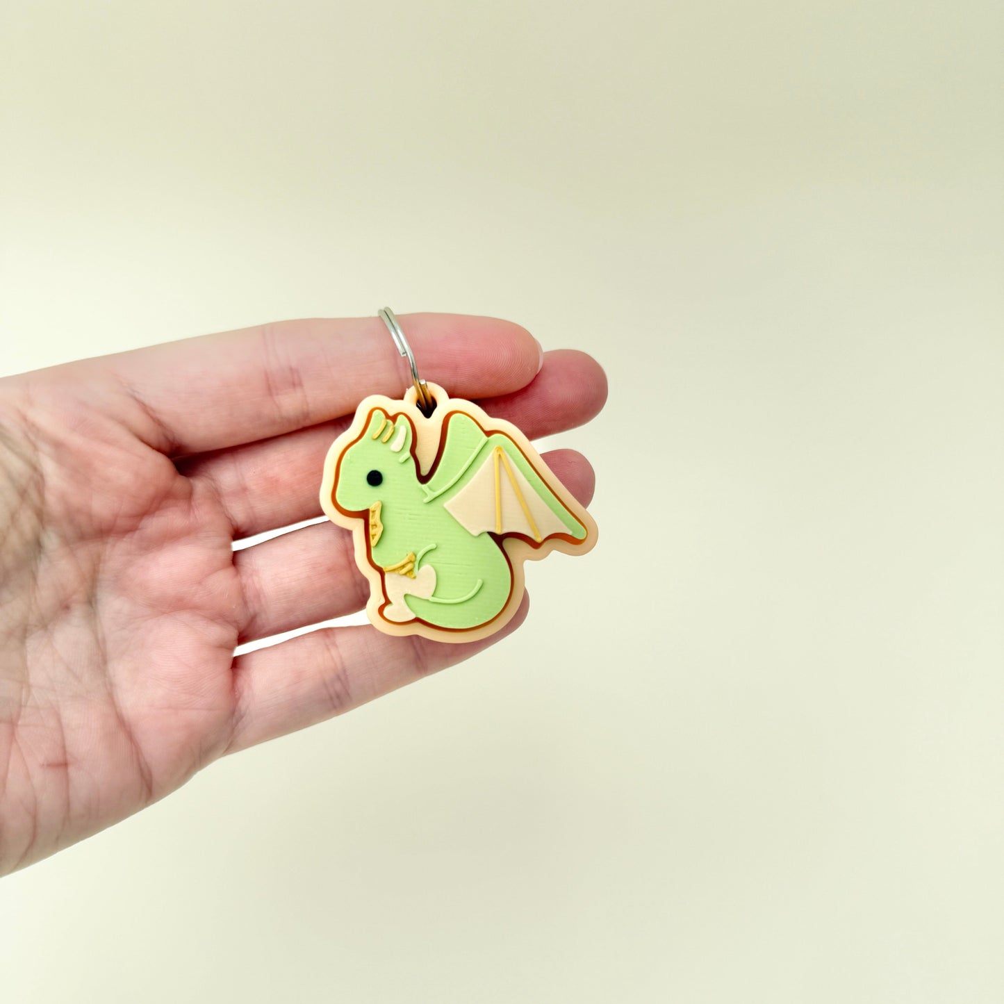 Small textured clicker fidget with a dragon design and soft raised detailing.