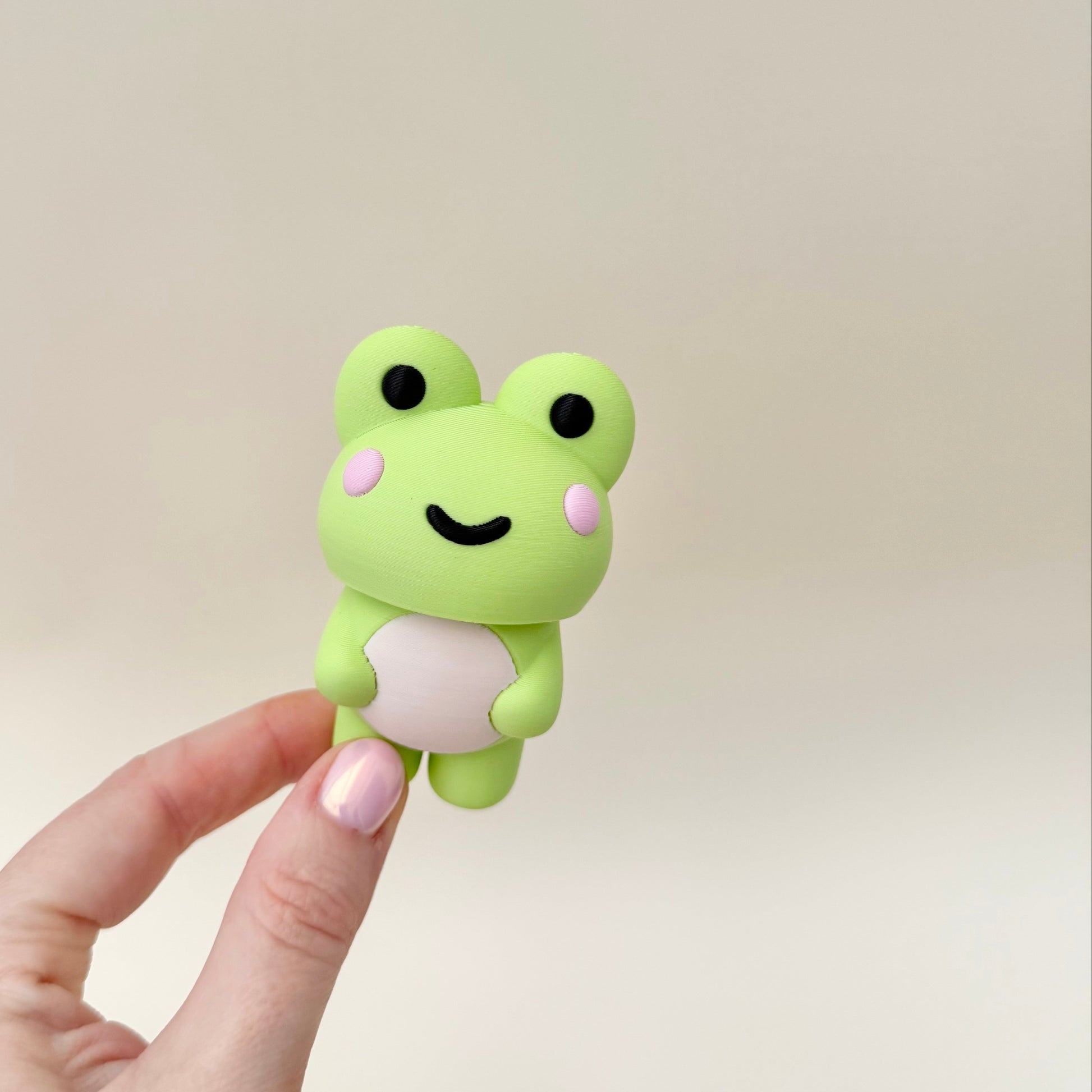 Cute green frog fidget clicker to help with anxiety and ADHD, the perfect travel sensory tool