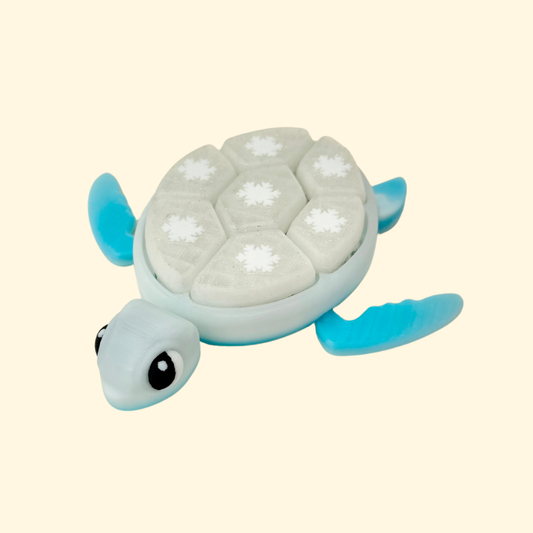 Winter turtle fidget with 7 click buttons and snowflake motifs for tactile stimming, 13 cm.
