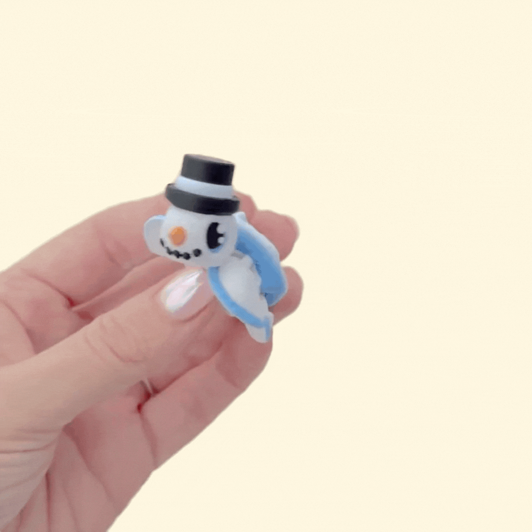 Portable articulated turtle fidget with winter theme; smooth and raised textures for soothing stims and pocket carry.
