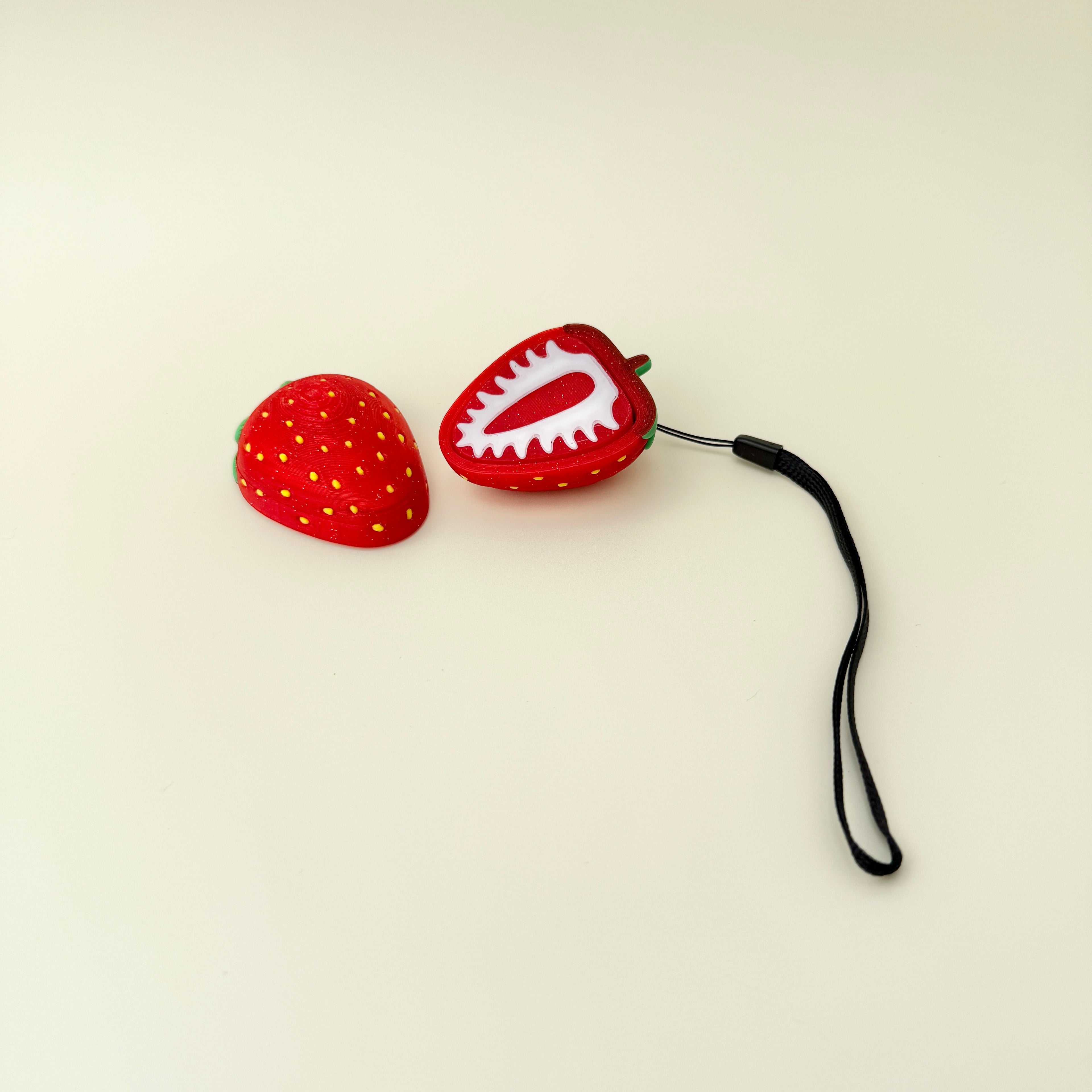 large strawberry slice shaped stim tool with wrist strap for sensory input
