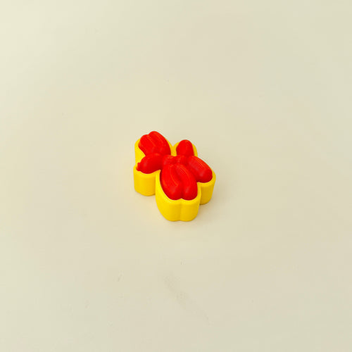 Compact sensory toy with a balloon animal design and pressable clicker centre.