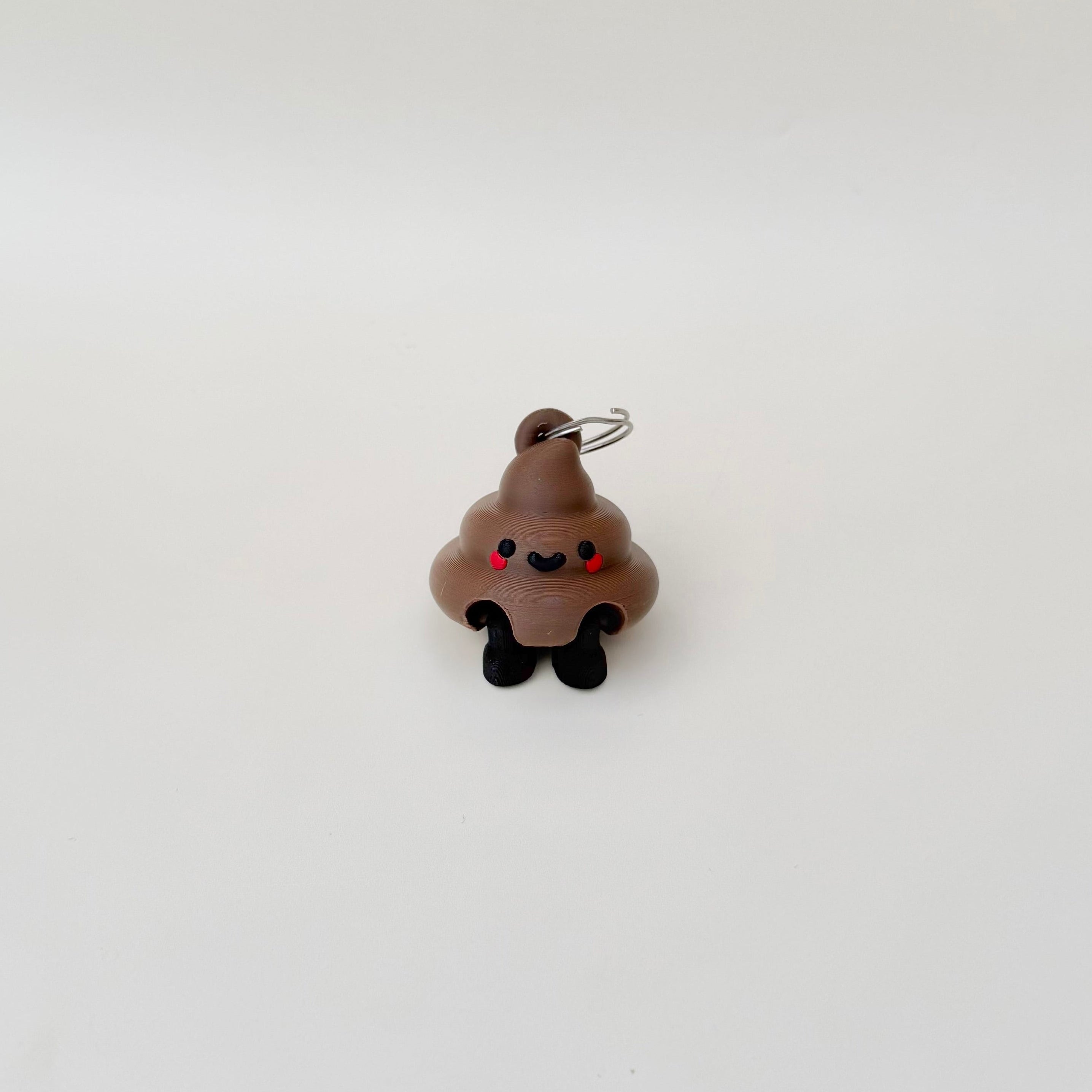 Playful poop keyring with articulated legs for fidgeting, perfect for teachers, carers and anyone who loves a laugh.
