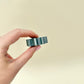 Gear-edge sensory spinner for stimming and grounding; firm ridges for thumb tracing; pocket-friendly.
