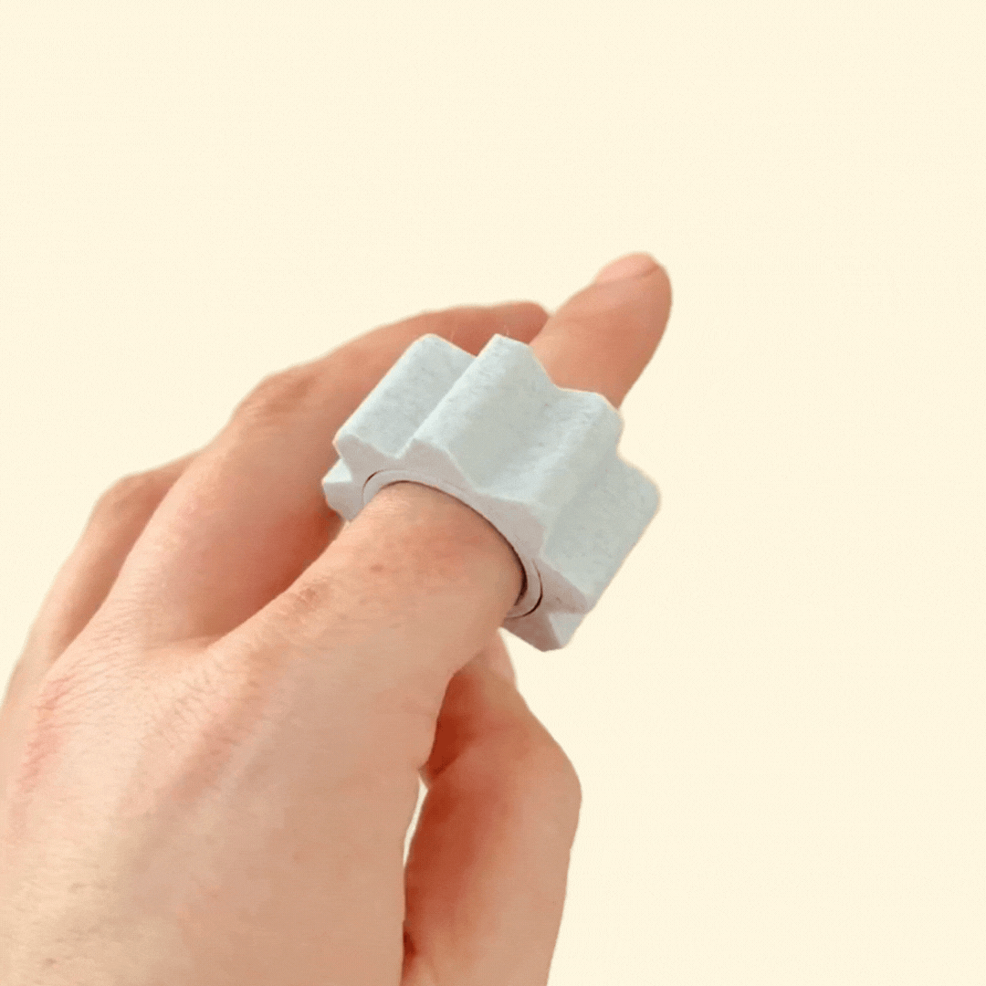 A set of three textured fidget rings with different sensory surfaces, designed for spinning and tactile play.