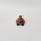 Novelty poop charm with moving legs and keyring attachment, ideal for light-hearted sensory comfort and everyday carry.
