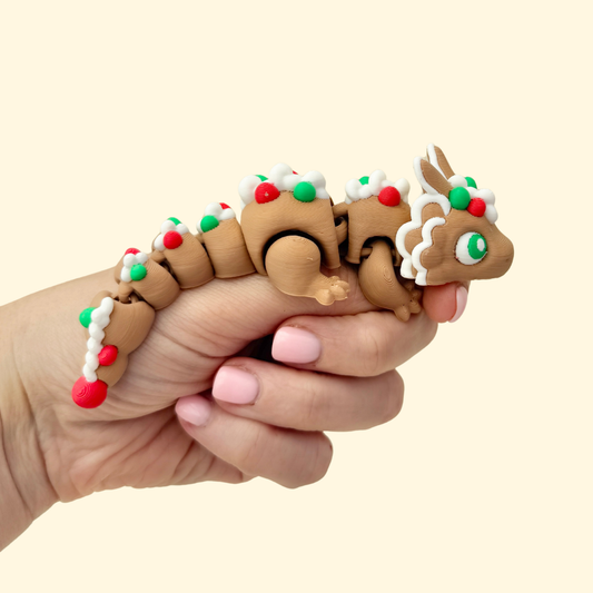 Festive cookie-brown articulated dragon with silver and green piping.
