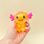 Visually satisfying squishy fidget with sparkle effect for tactile play and sensory comfort during screen breaks.
