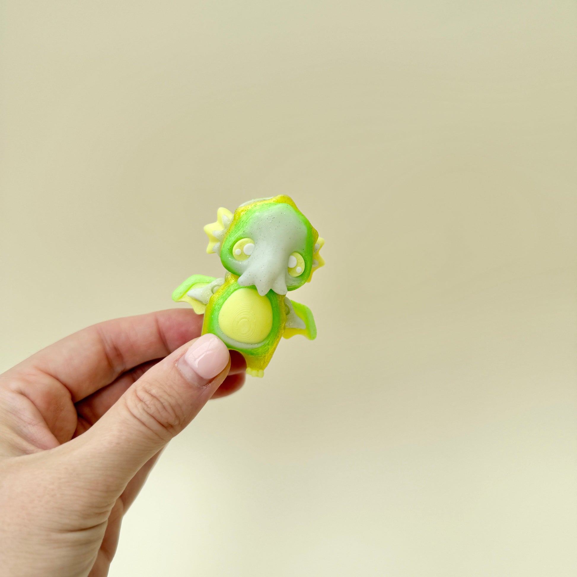 small collectible fidget figure with moving wings and gentle visual glow feedback

