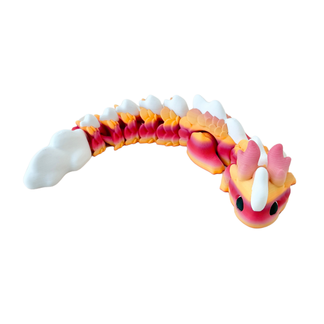 Kaida Scaled Dragon fidget toy featuring a white, peach, and pink gradient body with black and white eyes.