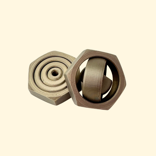 Metallic bronze hex-nut gyro spinner with quiet four-ring rotation.
