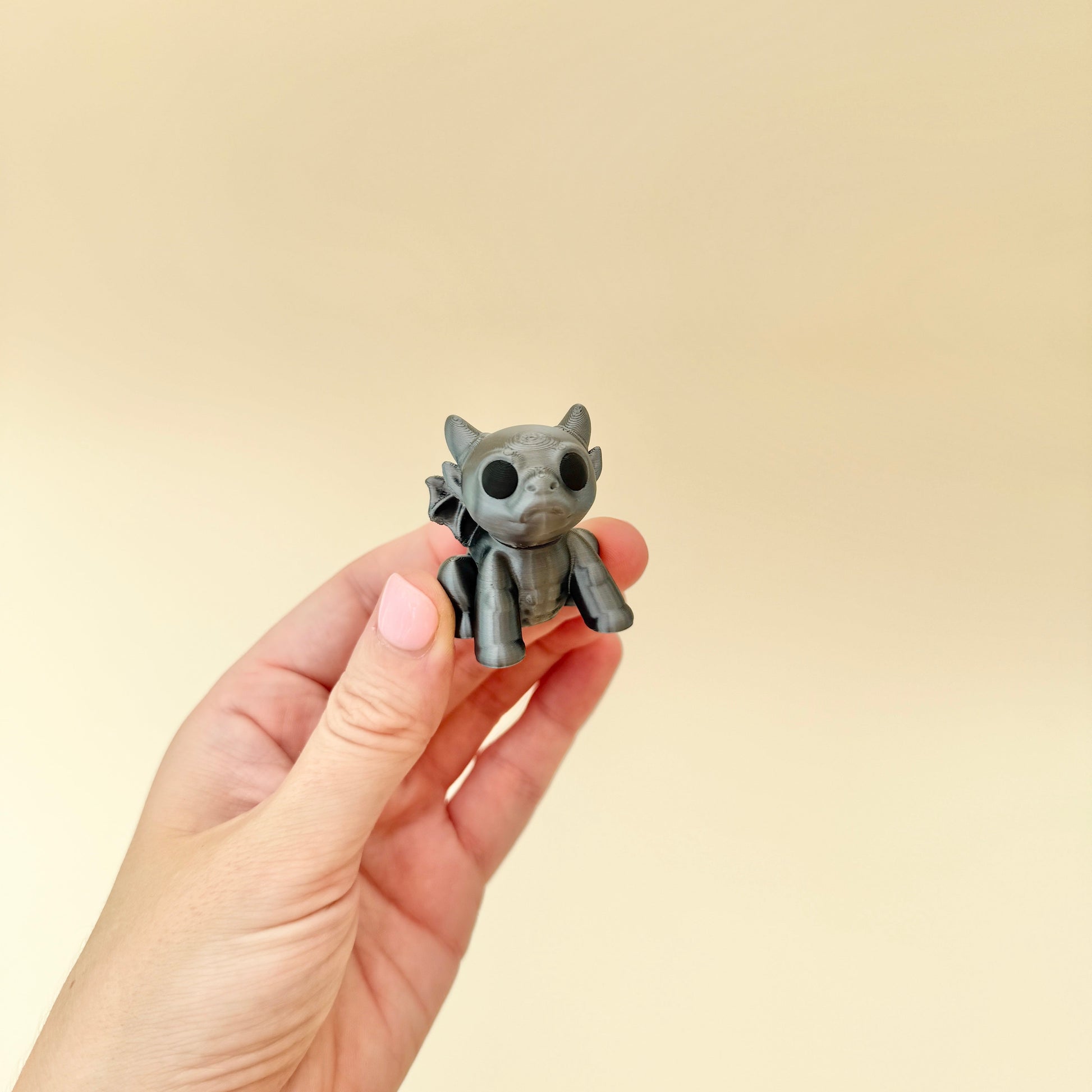 small winged gargoyle fidget suitable for desk use and sensory regulation
