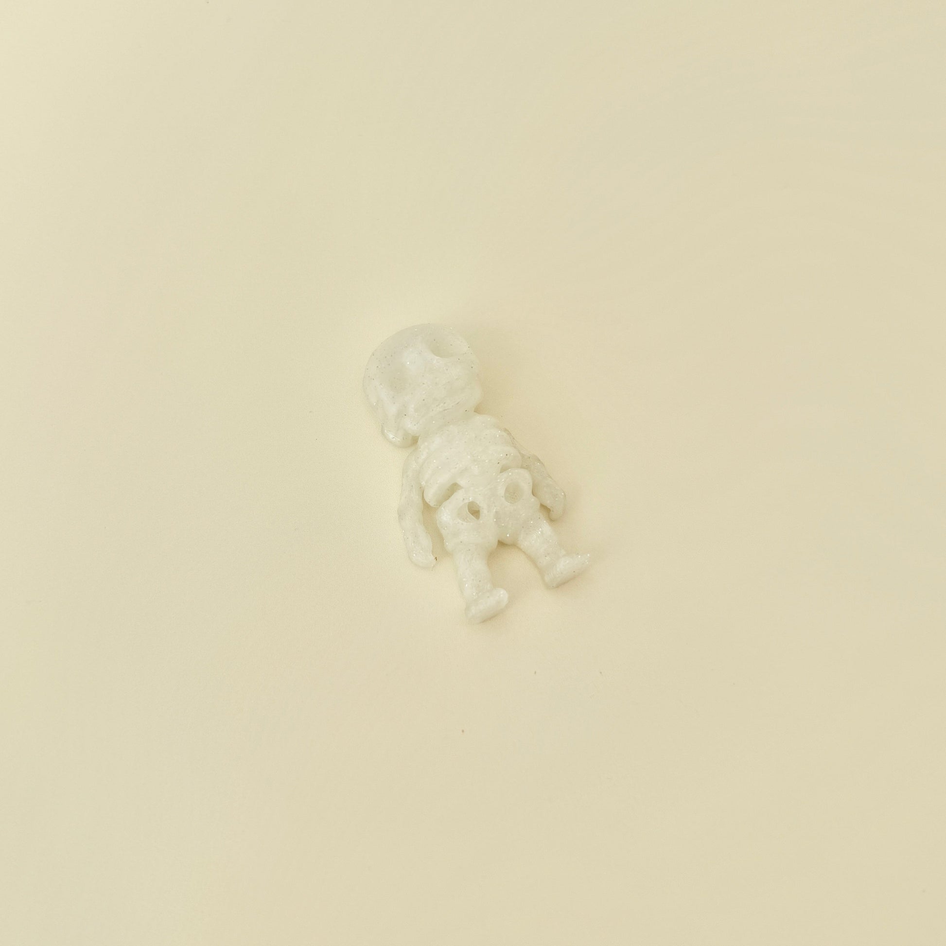 Small skeleton fidget with movable joints and sparkly frosted finish
