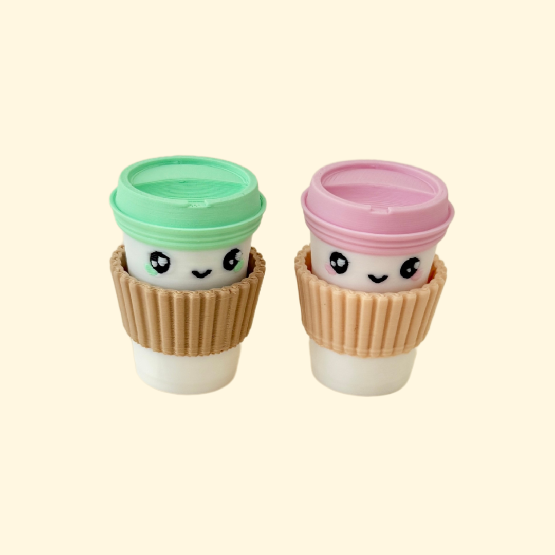 A mini fidget toy shaped like a coffee cup, featuring a press-to-click top.