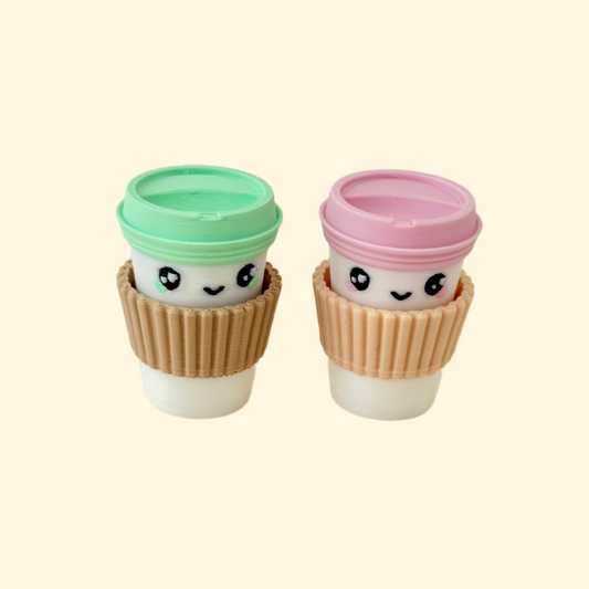 A mini fidget toy shaped like a coffee cup, featuring a press-to-click top.
