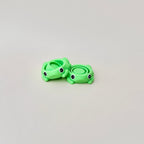 Frog fidget spinner with green body, small legs, and spinners in the middle, perfect for sensory play.