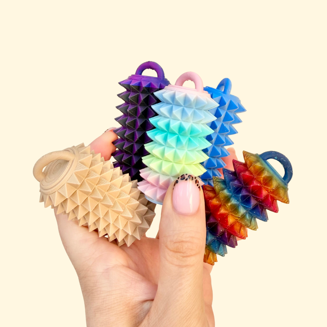 Compact tactile fidget used for squeezing, pressing, and rolling for sensory regulation.