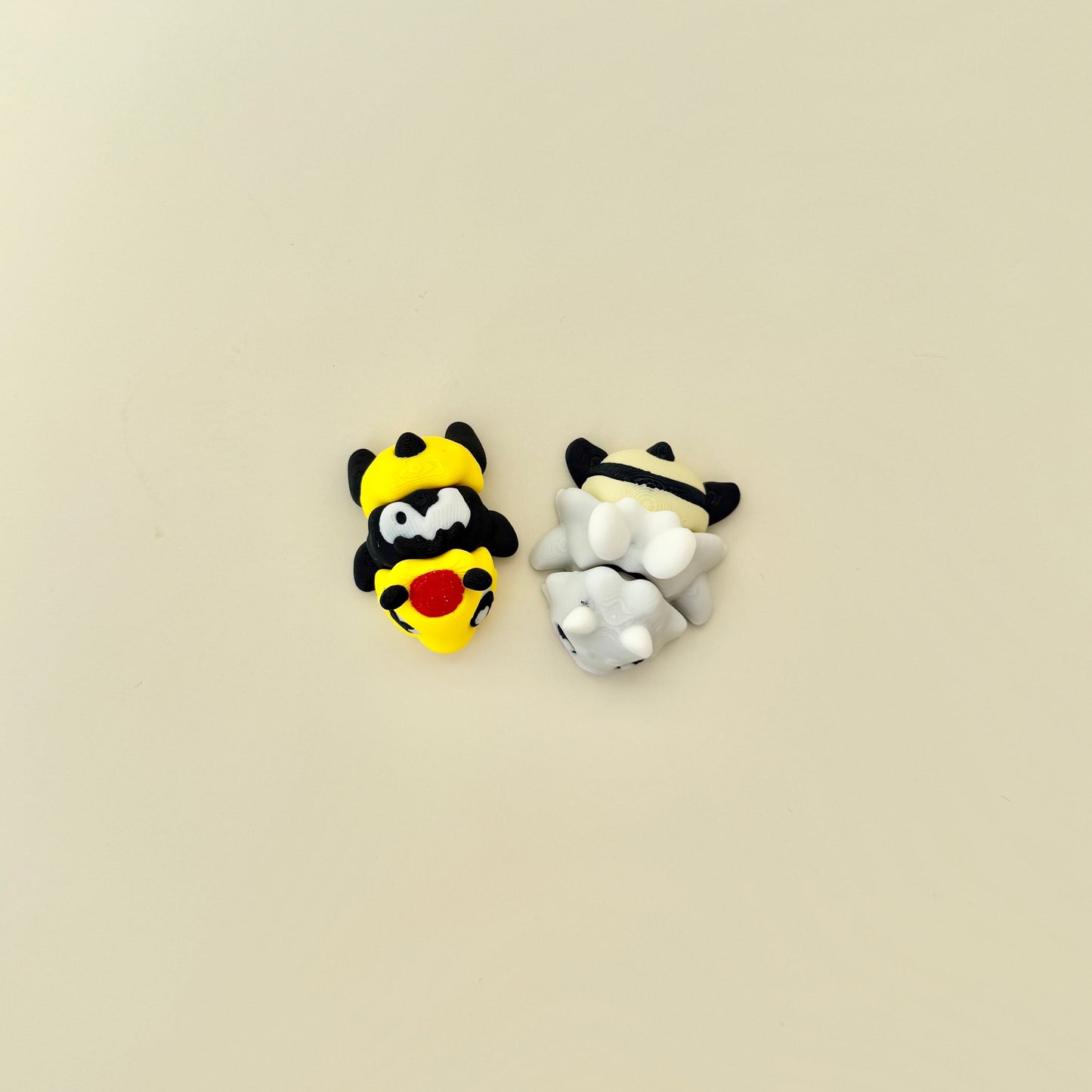 Collectable bee fidgets presented with matching accessory piece.
