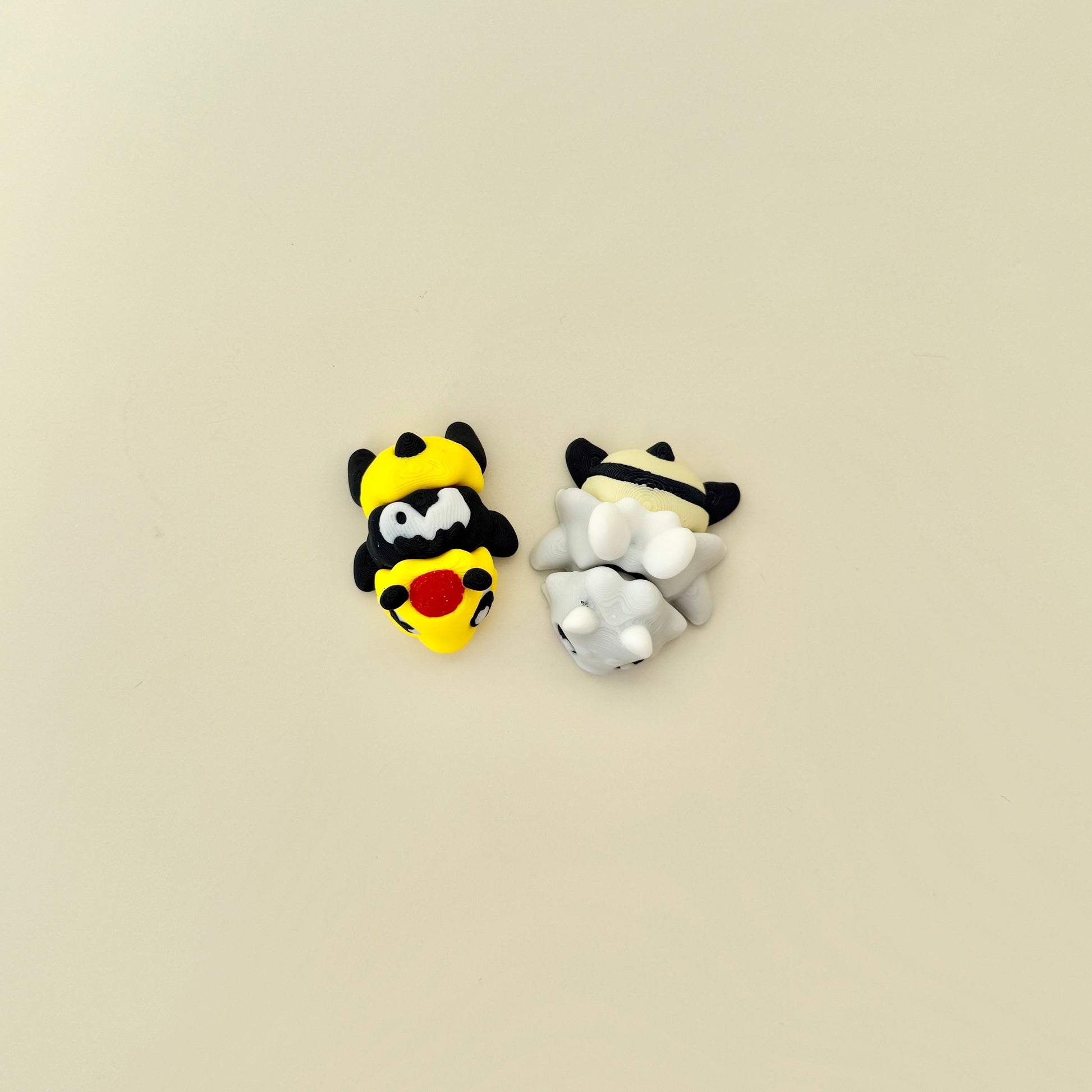 Collectable bee fidgets presented with matching accessory piece.
