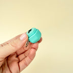 A stylish fidget keyring with a black raised letter, providing satisfying sensory feedback.