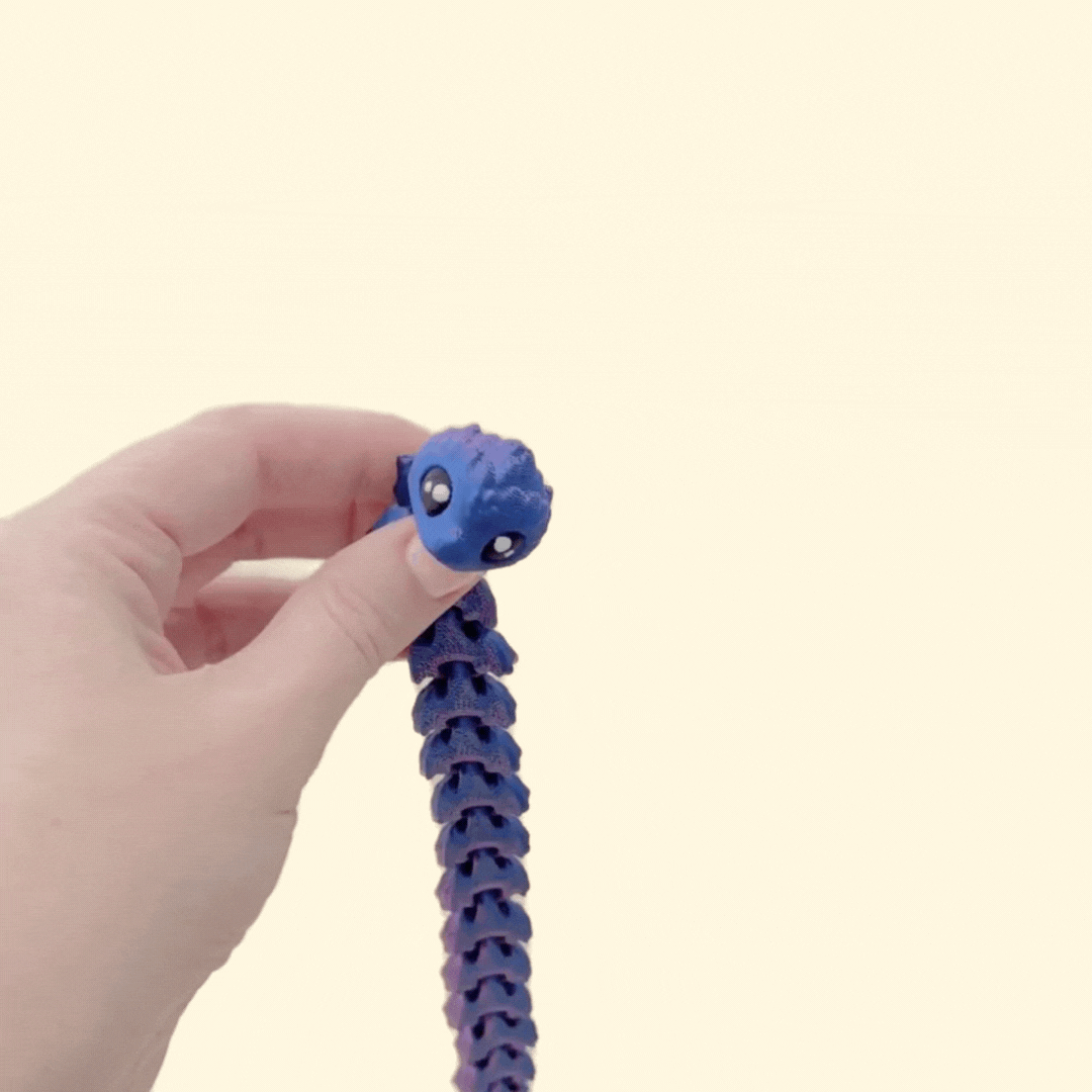 Raised scale texture and smooth joints for calm, repetitive movement and grounding.
