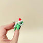 Small movable turtle in Santa colours designed for gentle tactile fidgeting.
