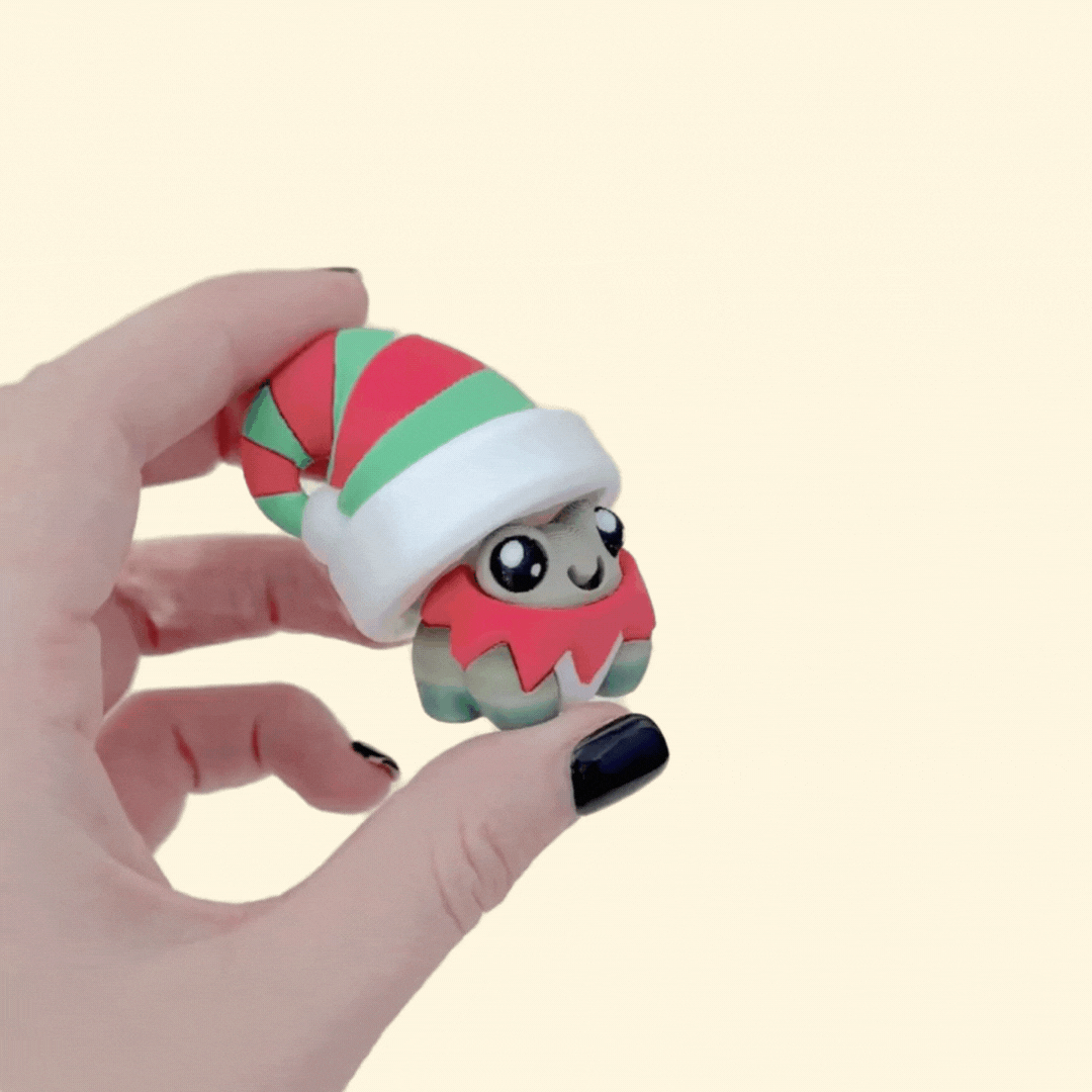 Cheerful Christmas frog clicker for focus and stimming; chunky build; smooth press; tactile edges.
