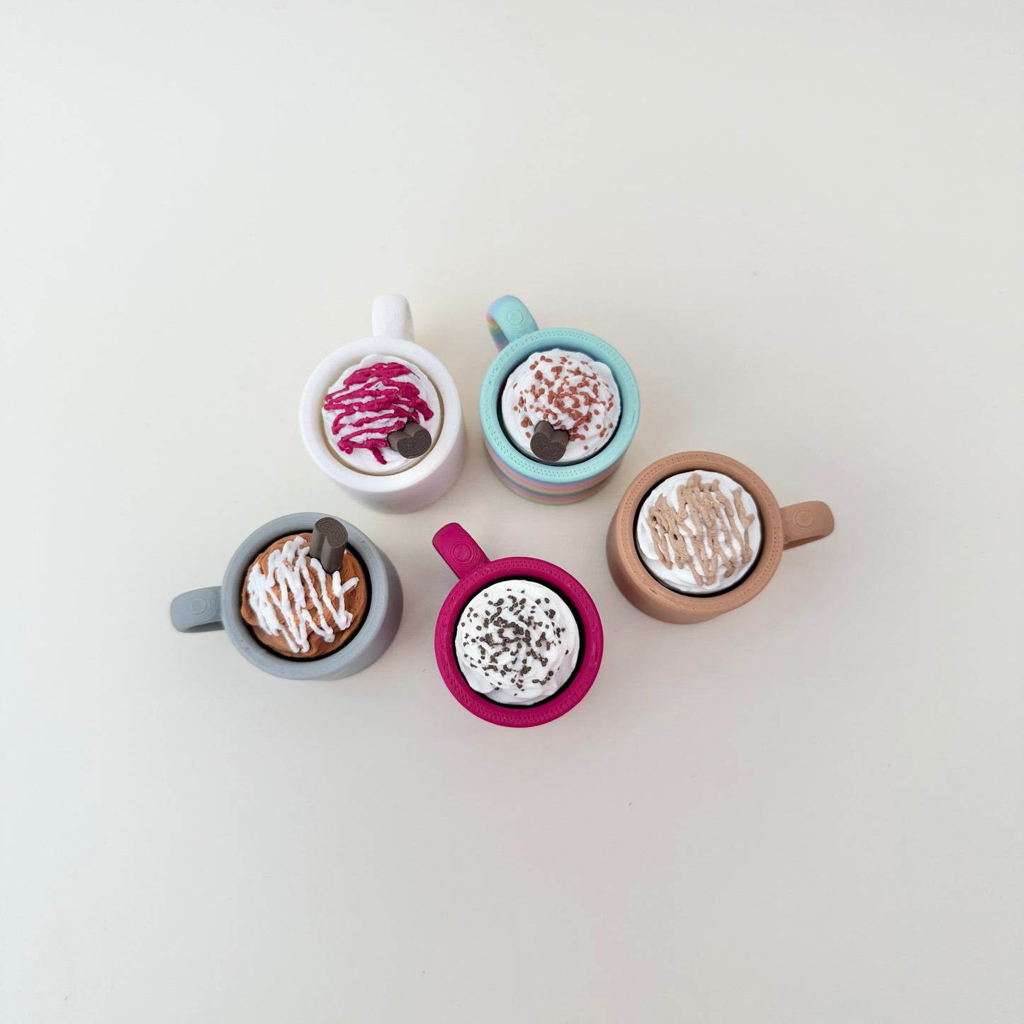 Mug-style sensory toy with press-to-click top; customisable look; helpful for focus breaks and regulation.