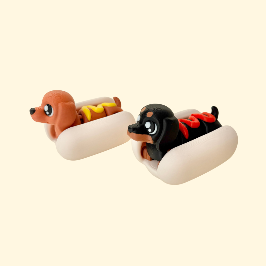 Articulated dachshund in a removable bun; tactile sensory fidget for stimming and desk play.

