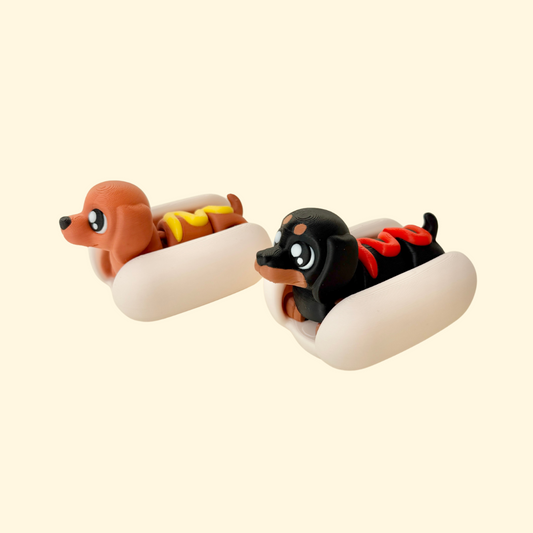 Articulated dachshund in a removable bun; tactile sensory fidget for stimming and desk play.
