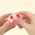 A cute fidget toy featuring a teddy bear inside a heart-patterned egg, designed for sensory play and gifting.