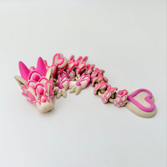 Valentine themed articulated dragon fidget with raised icing style detailing and satisfying joint movement.
